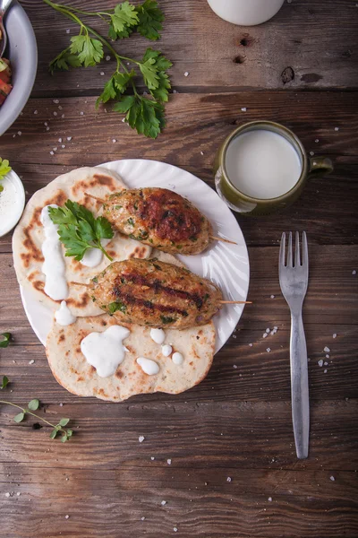 Kofta with flatbread on plate with salad Royalty Free Stock Photos