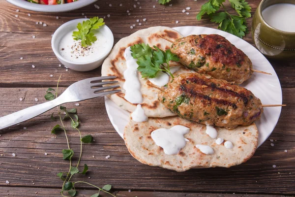 Kofta with flatbread on plate with salad Stock Photo