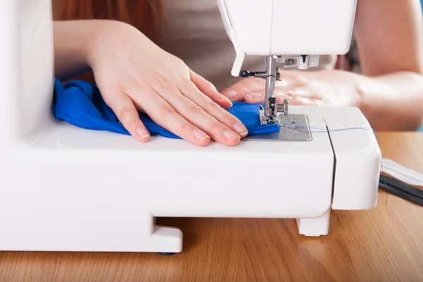 Young woman sewing fabric — Stock Photo, Image