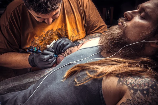 Especialista em tatuagem no trabalho em sala de tatuagem — Fotografia de Stock