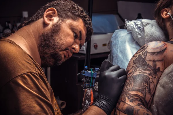 Tattooer pózol tetováló szalon — Stock Fotó