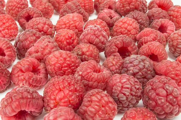 Fresh raspberries scattered on white background — Stock Photo, Image