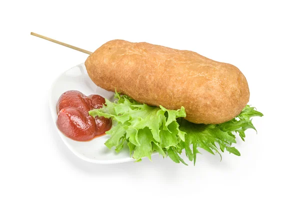 Corn dog on plate with ketchup and lettuce over white background — Stock Photo, Image