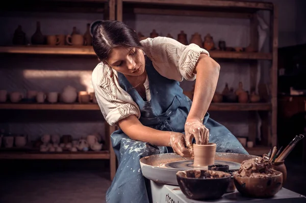 Encantador maestro femenino demuestra el proceso de fabricación de platos de cerámica utilizando la tecnología antigua. Fabricación artesanal. — Foto de Stock