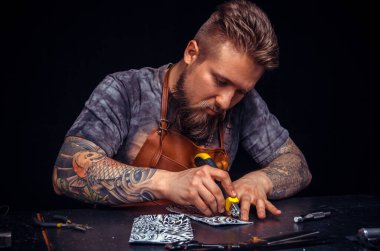 Deri atölyesinde deri üreten bir zanaatkar.