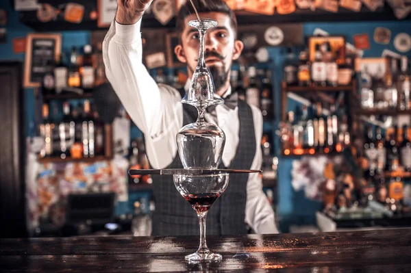 Portret van barkeeper demonstreert het proces van het maken van een cocktail — Stockfoto