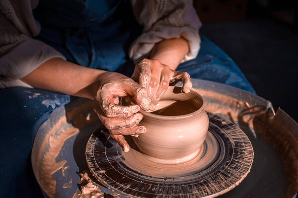 Craftsman master making ceramic pottery on wheel. Making ceramic dishes. Close-up.
