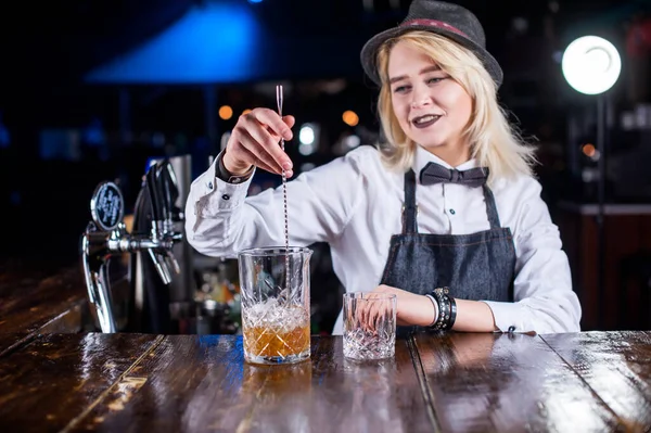 Professional woman bartender is pouring a drink — Stock Photo, Image