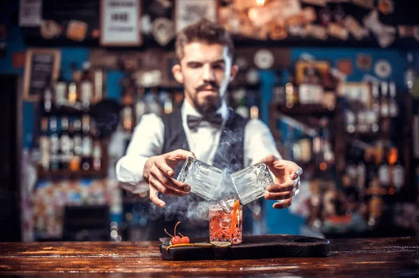 Fiducioso barman aggiunge ingredienti a un cocktail mentre in piedi vicino al bancone del bar in discoteca — Foto Stock