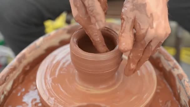 Hands of a potter, creating an earthen jar — Stock Video