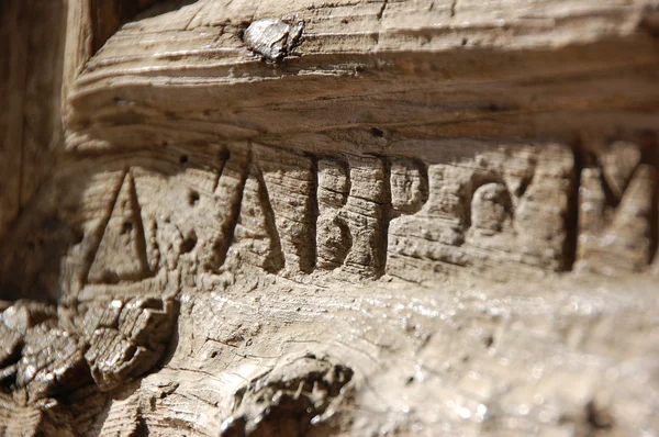 Letters carved into door — Stock Photo, Image