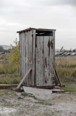 Wooden outhouse on the street clipart