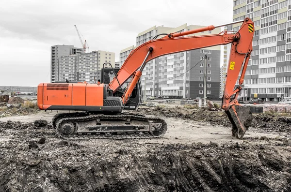 Orange excavator on a construction site — Stock Photo, Image