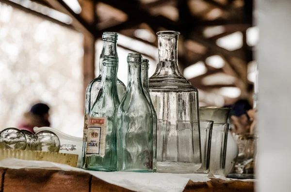 Empty glass bottles at a flea market — Stock Photo, Image