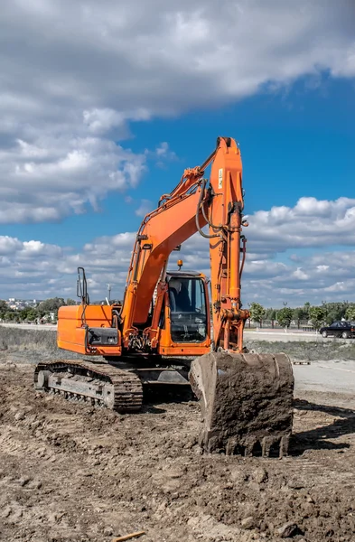 Orange excavator at work — Stock Photo, Image