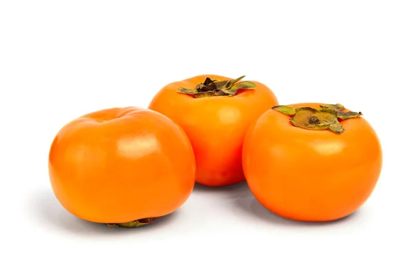 Three persimmons on white background — Stock Photo, Image