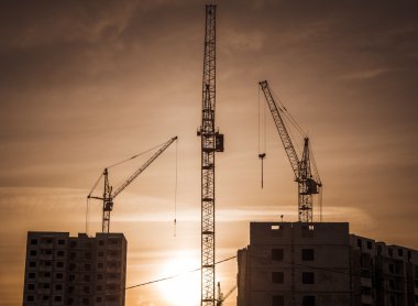 Construction of new skyscraper and building crane clipart