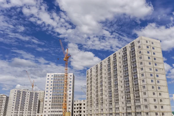 Construcción de edificios de varios pisos y grúas grandes — Foto de Stock