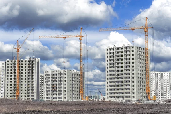 Novo edifício e guindastes highrise — Fotografia de Stock