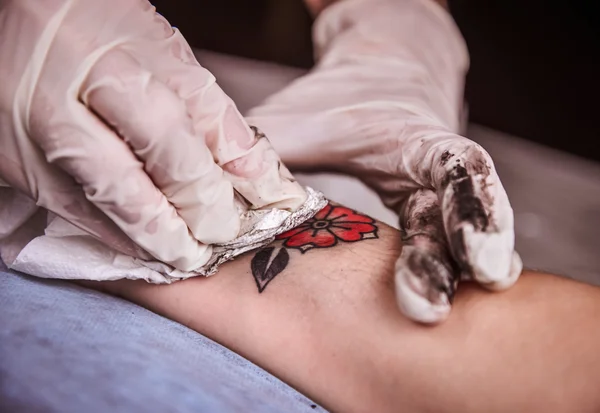 Tattooer showing process of making tattoo — Stock Photo, Image