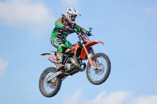 PENZA, RUSSIA - JUNE 18, 2011: An unnamed member of freestyle MX team gives a display of stunts & tricks to the public. — Stock Fotó