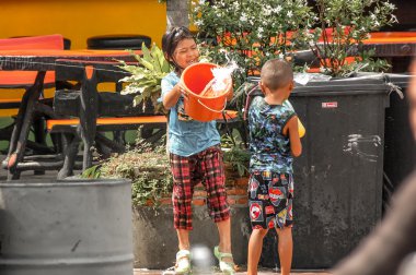 PATTAYA, THAILAND - APRIL 18, 2013: Foreign tourists and Thai people enjoy splashing water.