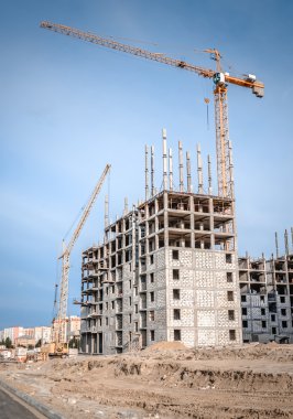 Construction of highrise houses and lifting crane clipart
