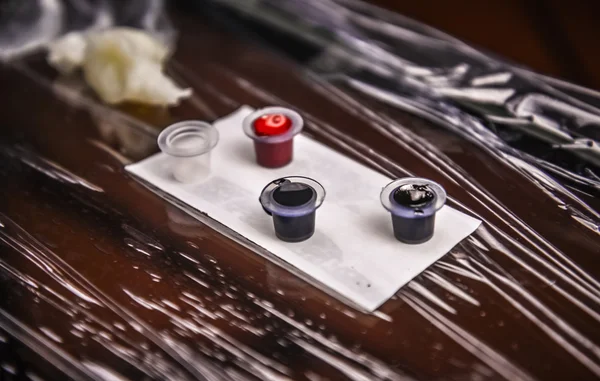 Tattoo ink poured into caps — Stock Photo, Image