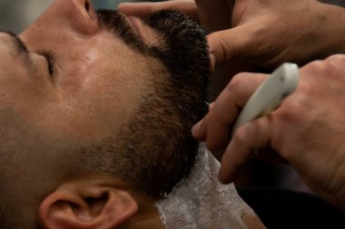 Close up barber shaving clipart