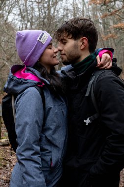 Genç bir Kafkasyalı çift, sonbahar ormanı yolunda birbirlerinin gözlerine bakar.