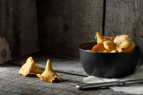 Mushrooms chanterelle on wooden vintage background