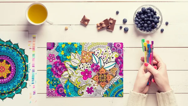 Flat lay, female coloring adult coloring books, new stress relieving trend — Stock Photo, Image