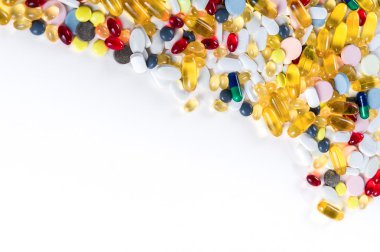 Birçok farklı renkli ilaç ve beyaz arka plan üzerinde yukarıdan hapları