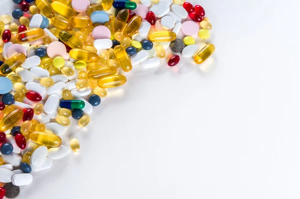 Muitos medicamentos coloridos diferentes e pílulas de cima no fundo branco com espaço de cópia — Fotografia de Stock