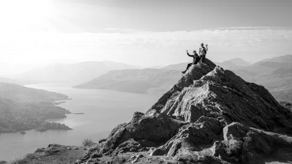 Two female hikers on top of the mountain enjoying valley view, Ben A'an, Loch Katrina, Highlands, Scotland, UK — Stock Photo, Image