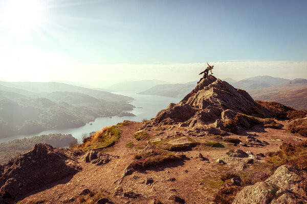 Two female hikers on top of the mountain enjoying valley view, Ben A'an, Loch Katrina, Highlands, Scotland, UK