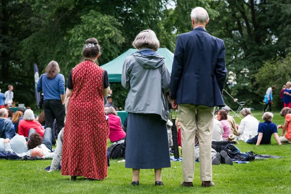 Older generation, seniors, enjoying an outdoors music, culture, community event, festival. — Stock Photo, Image