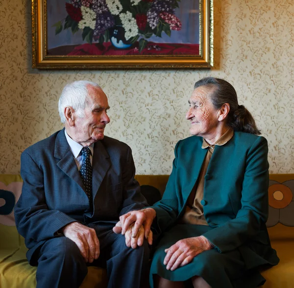 Cute 80 plus year old married couple posing for a portrait in their house. Love forever concept. — Stock Photo, Image