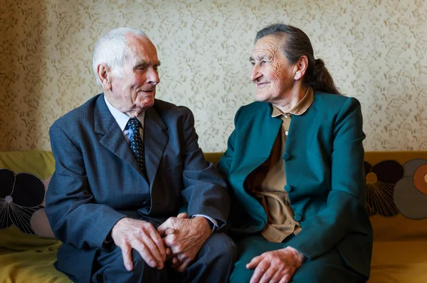 Cute 80 plus year old married couple posing for a portrait in their house. Love forever concept. — Stock Photo, Image