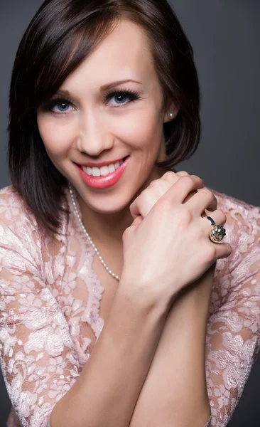 Verticale kleurenafbeelding van van een mooie jonge vrouw lachen. mooie jonge vrouw lachen met gezonde gezicht en schone huid geïsoleerd op grijze achtergrond — Stockfoto