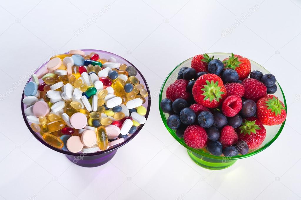 Healthy lifestyle, diet concept, Fruit and pills, vitamin supplements with copy space on white background