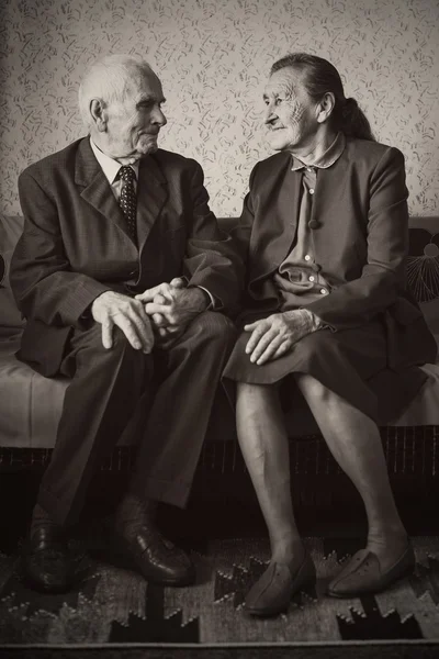 Cute 80 plus year old married couple posing for a portrait in their house. Love forever concept. — Stock Photo, Image