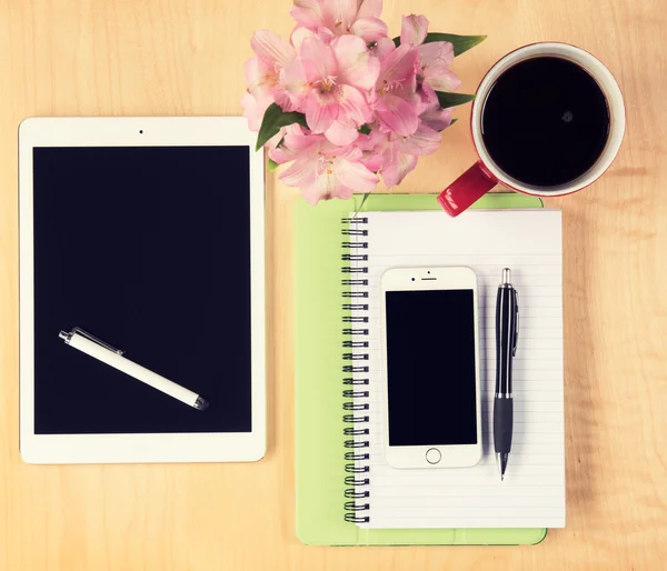 Office table with digital tablet, smartphone, reading glasses and cup of coffee. View from above with copy space — Stock Photo, Image