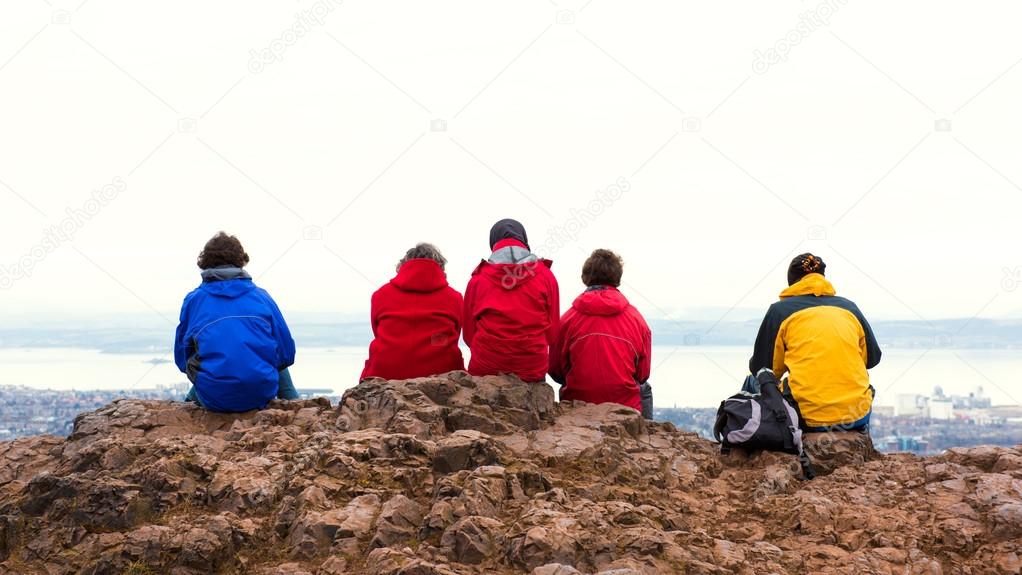 Family enjoying view of Edinburgh from top of Arthurs seat, ancient volcano, Scotland, UK
