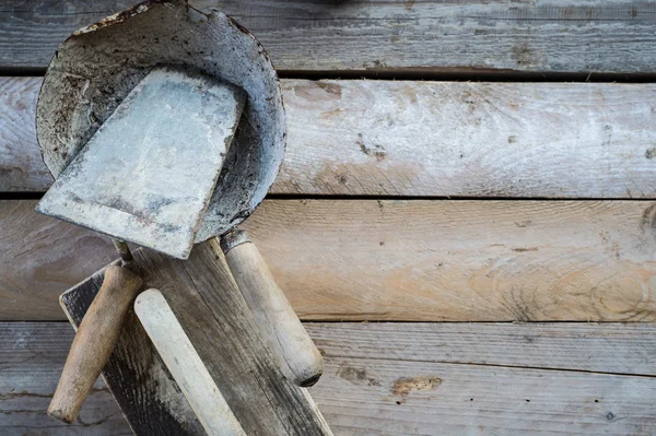 Set of old used masonry tools on a rough wooden surface — Stock Photo, Image