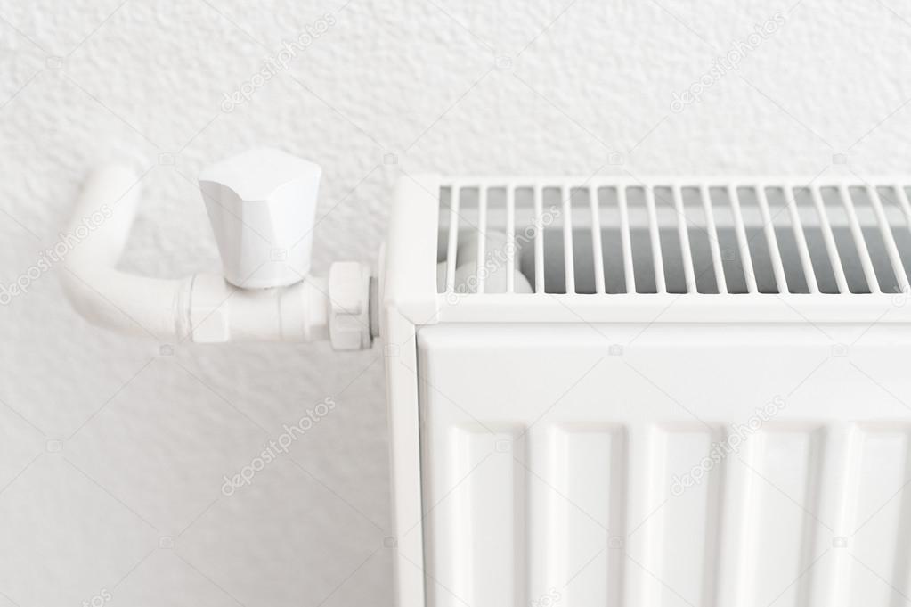 White heating radiator in an apartment. Detail shot with copy space