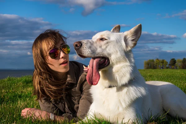 Young attractive girl with her pet dog at seaside — Stock Photo, Image