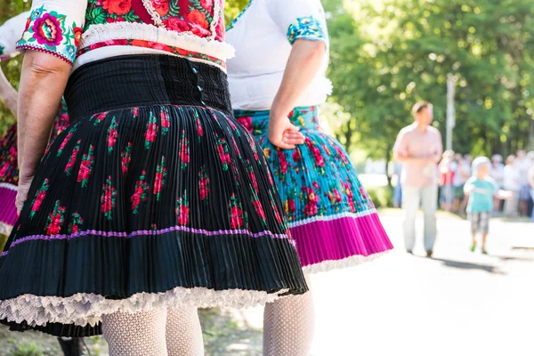 Anonymous senior female friends in folklore costumes — Stock Photo, Image