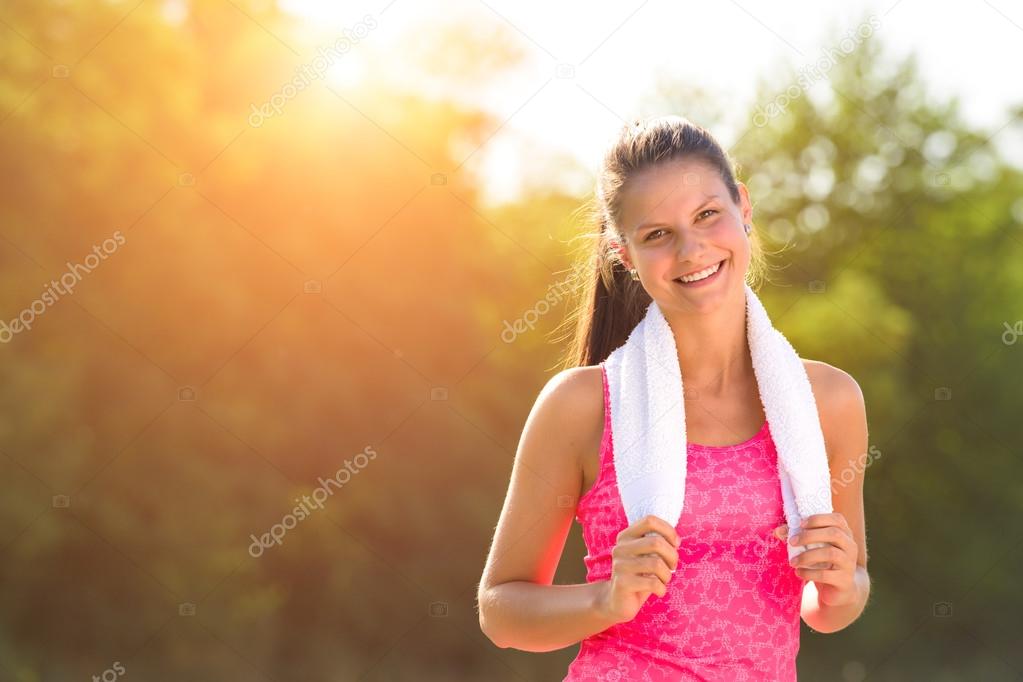 Attractive female taking a break after jogging