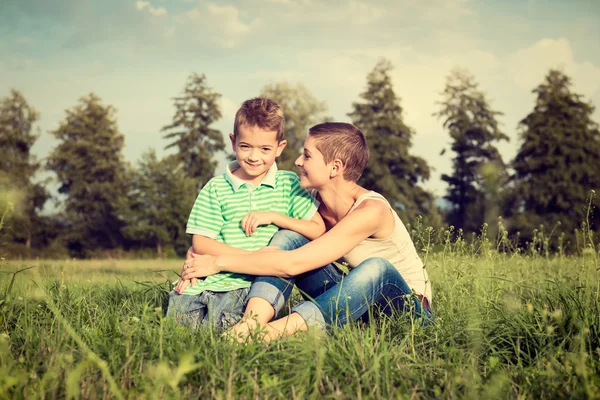 Moeder en zoon poseren voor een outdoor portret, glimlachend — Stockfoto